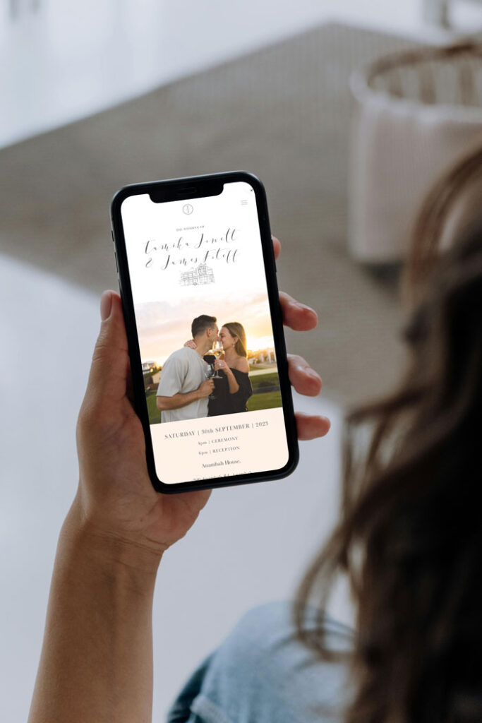 Woman holding iphone displaying custom wedding website for australian wedding