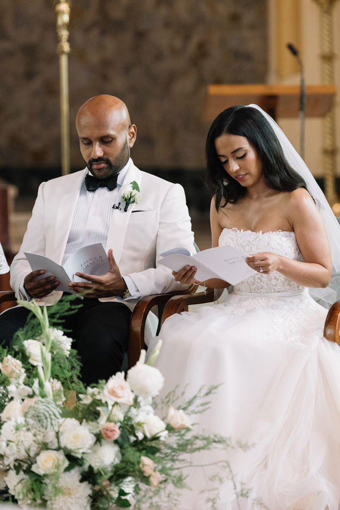 couple on their wedding day reading ceremony booklet