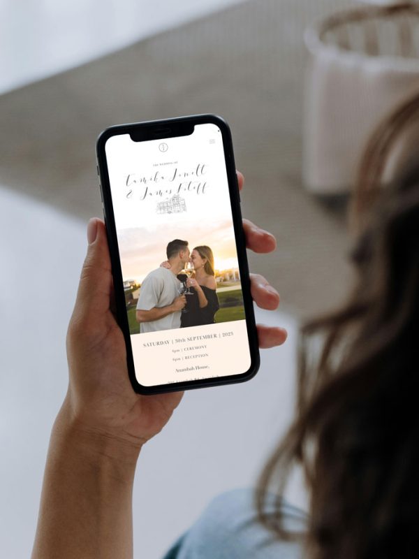 Woman holding iphone displaying custom wedding website for australian wedding
