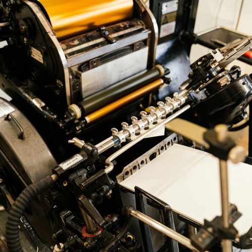 Foil printing press printing gold foil wedding invitations. Full service wedding invitations, stationery, and signage