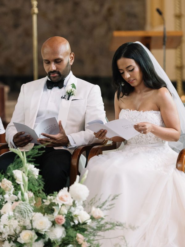 couple on their wedding day reading ceremony booklet